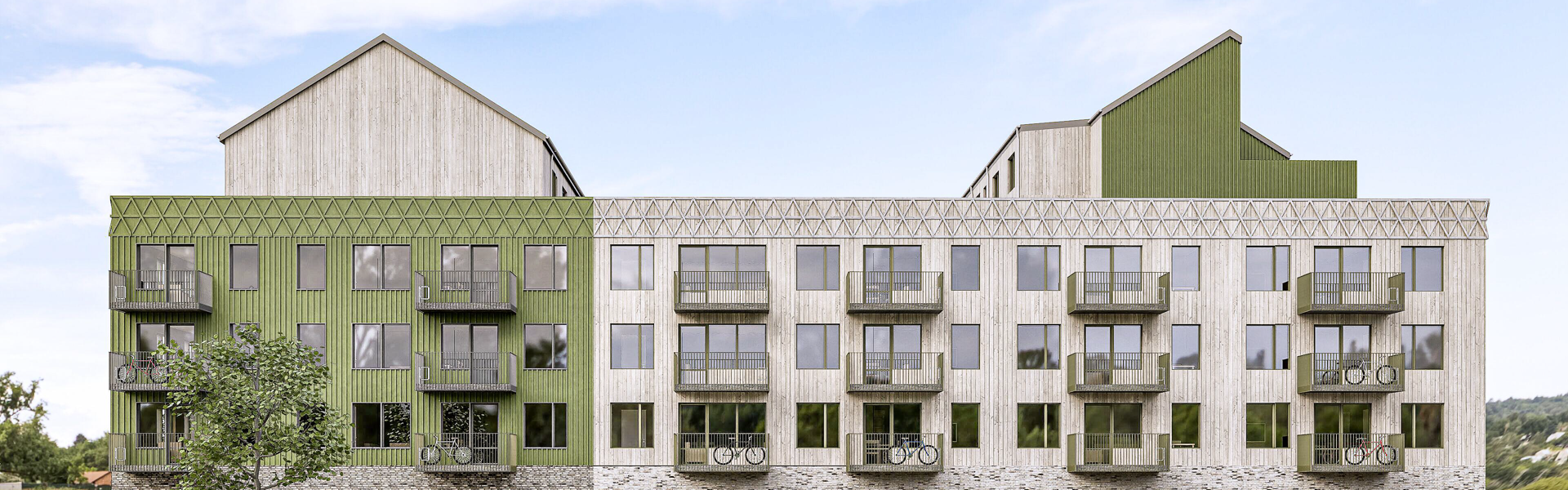 Visionbild över byggnaden med grön och grå fasad