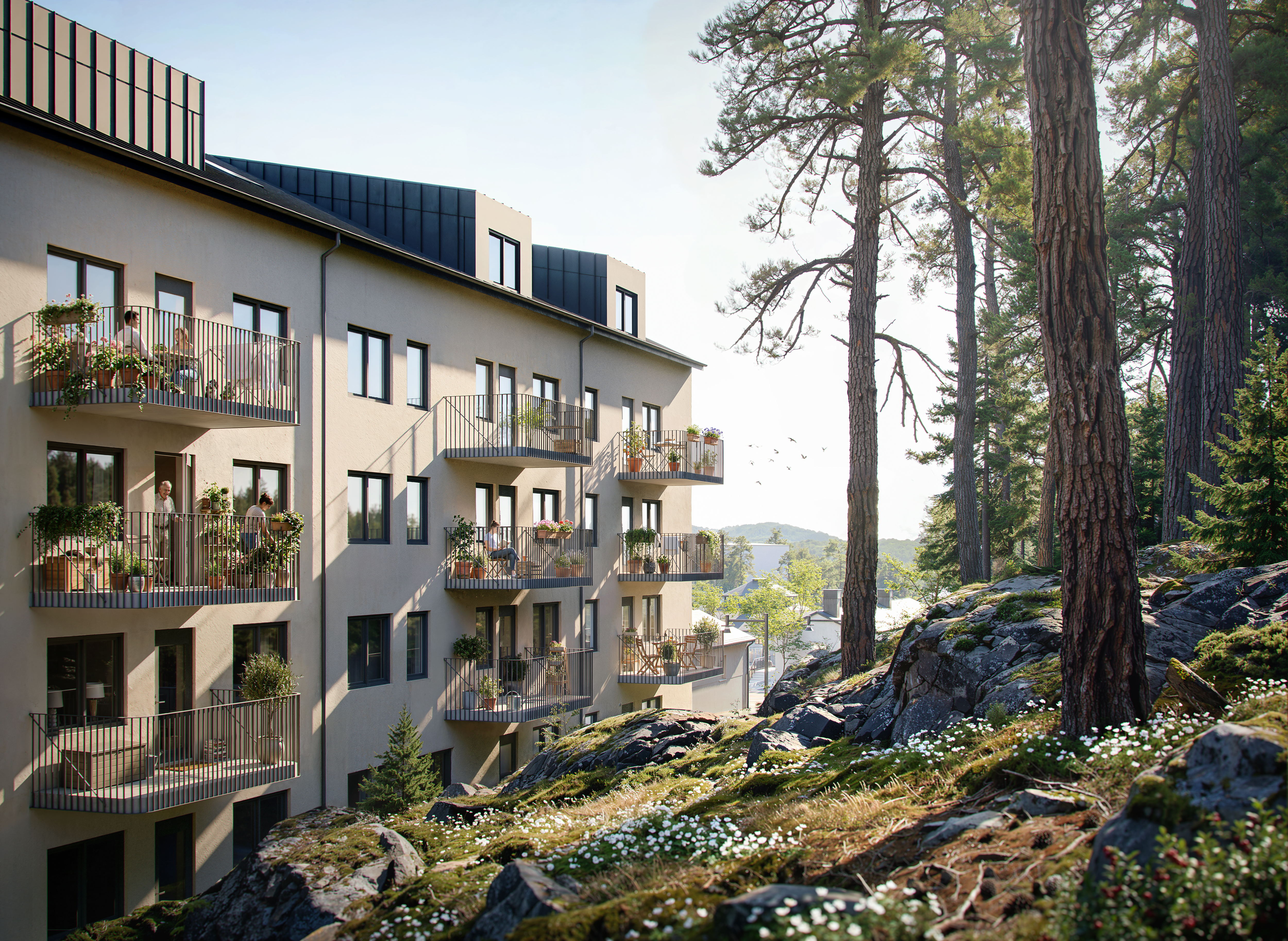 Flerbostadshus med balkonger intill skog, klippor och tallar i en naturnära miljö.