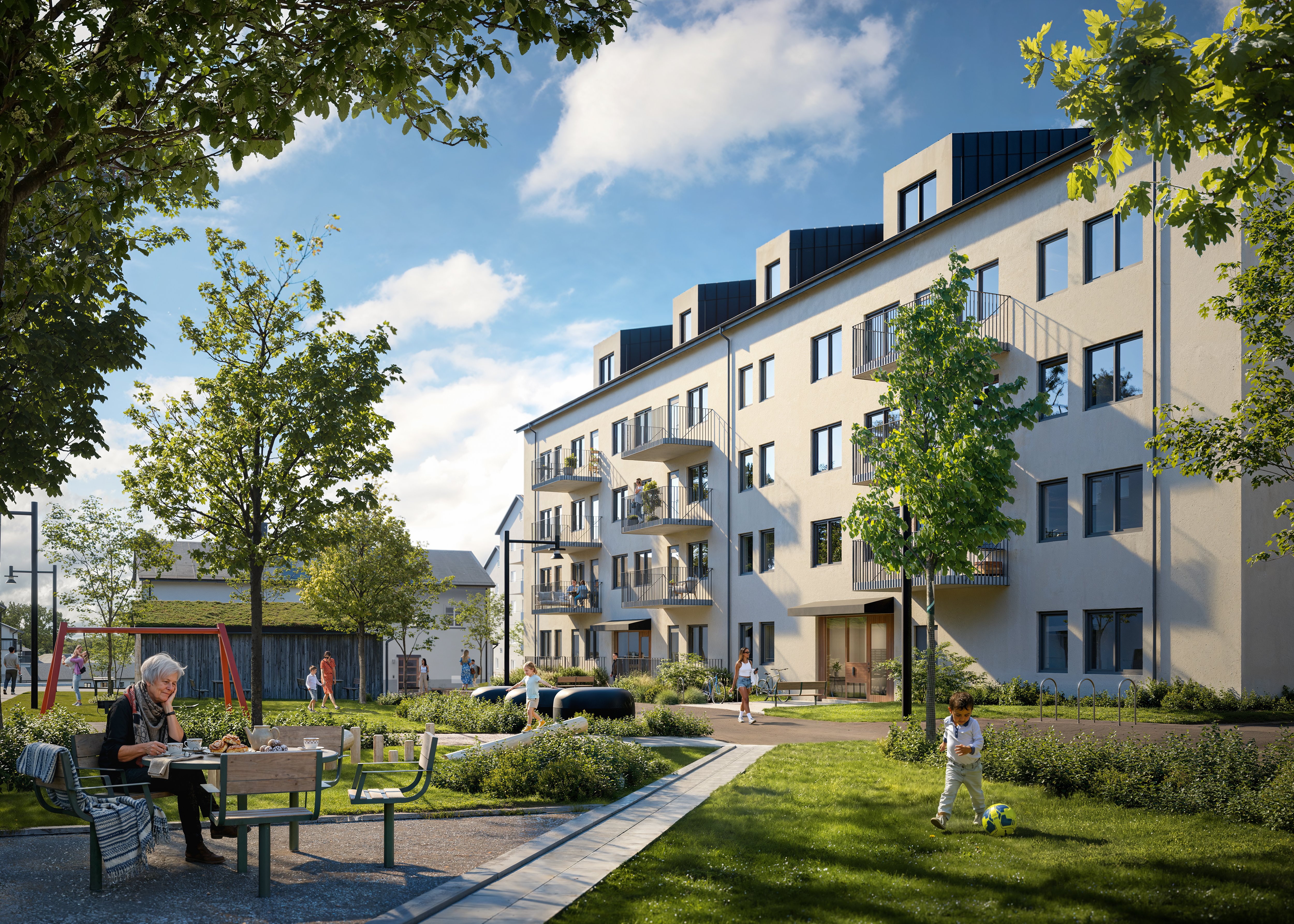 Gårdsmiljö framför ett modernt flerbostadshus med gräsmattor, träd, gångvägar och lekytor.