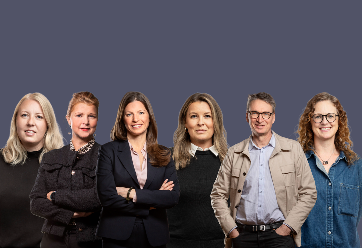 Sex personer från Stena Fastigheter står på rad mot en enfärgad mörkgrå bakgrund. 