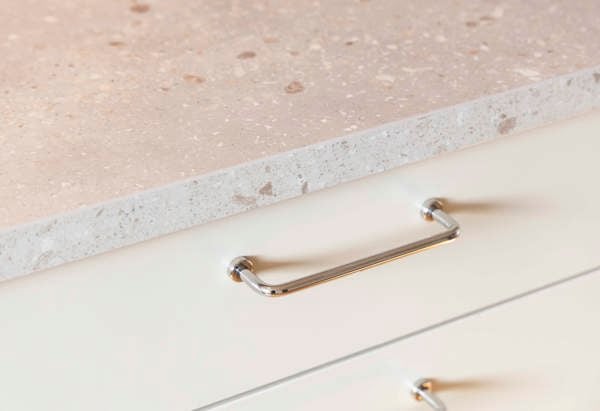 Detaljbild från en plusrenoverad lägenhet med fokus på bänkskiva och handtag