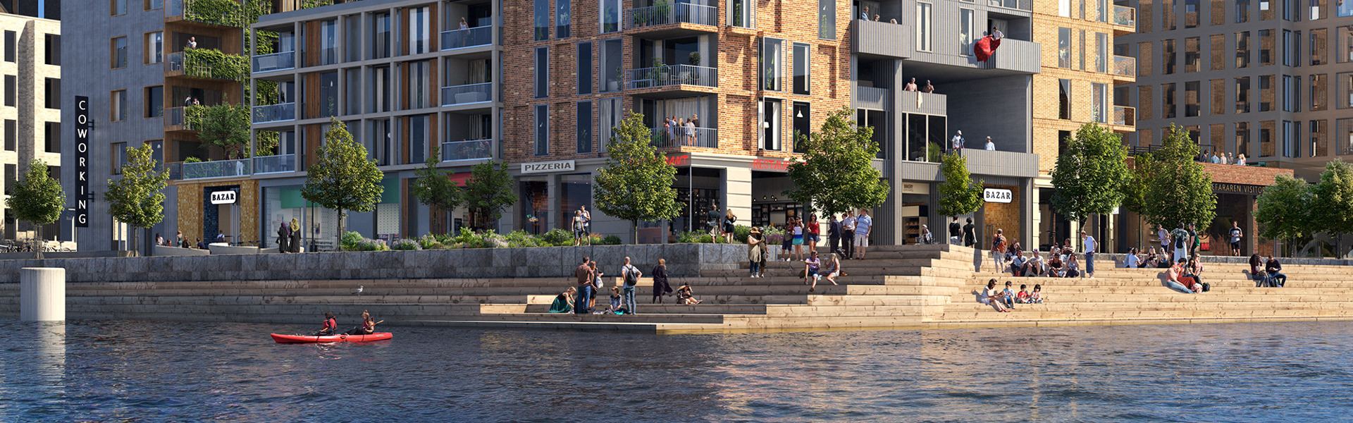"Vy över moderna bostadshus och kontorsbyggnader i flera våningar vid en kaj. Flera människor vistas på trappor och gångvägar längs vattnet, och en person paddlar kajak i förgrunden. Byggnaderna har inslag av gröna tak och stora fönster. Soligt väder med blå himmel och några moln