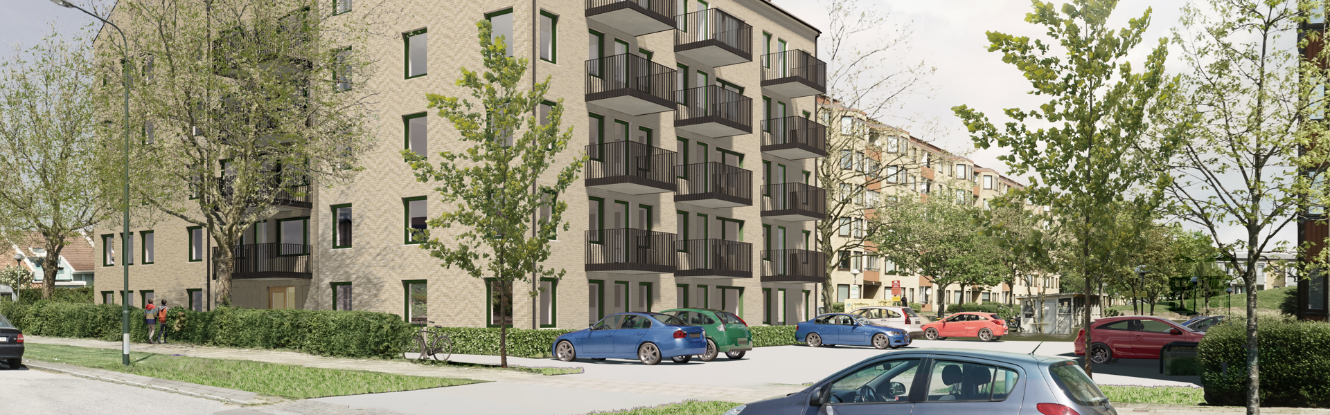 En modern flerfamiljsbyggnad i ljus tegel med svarta balkonger och stora fönster. Framför huset finns en parkeringsplats med flera bilar, samt en grönskande omgivning med träd och buskar. I bakgrunden syns fler bostadshus och en gångväg där ett par personer promenerar.