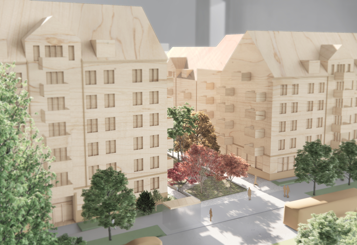Trämodell av ett bostadskvarter med flera flerbostadshus, träd och en innergård med gångvägar.