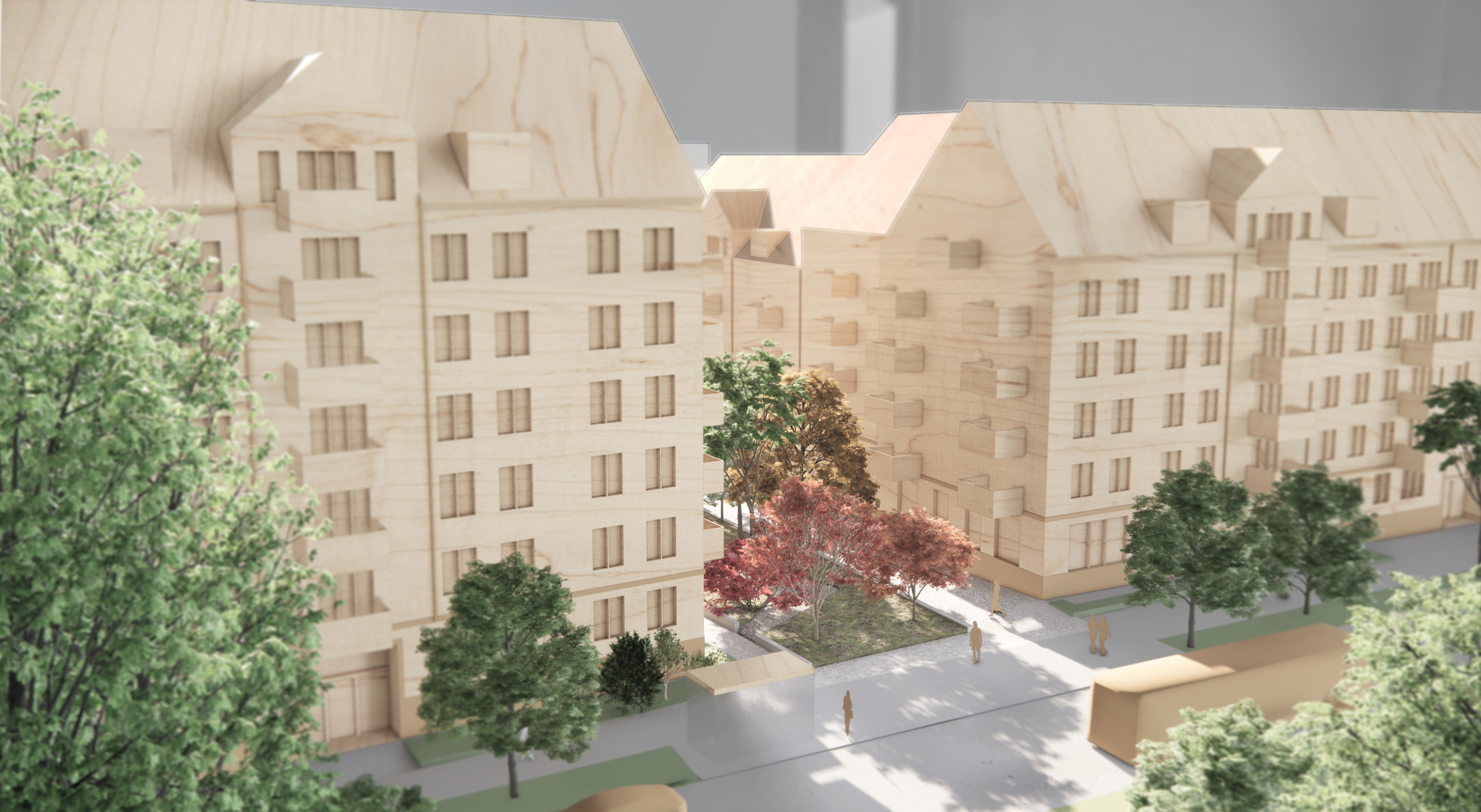 Trämodell av ett bostadskvarter med flera flerbostadshus, träd och en innergård med gångvägar.