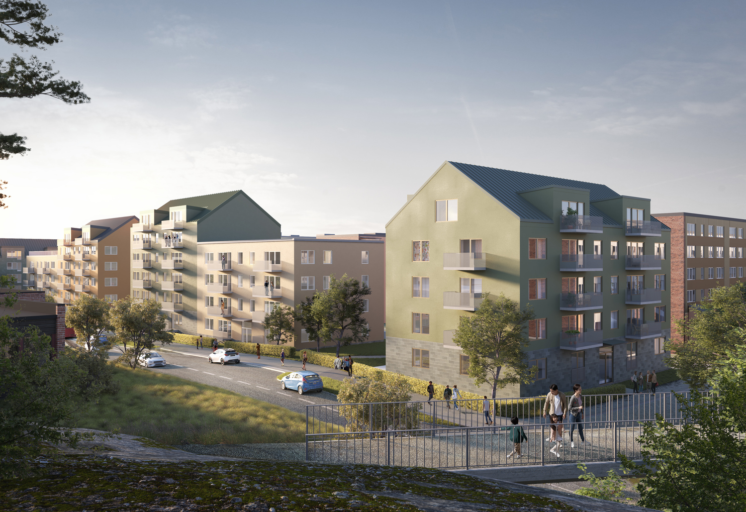 Visuell vy över kvarter med flerfamiljshus. Bro över väg i förgrund och hus medgröna och beigea fasader i bakgrund. 