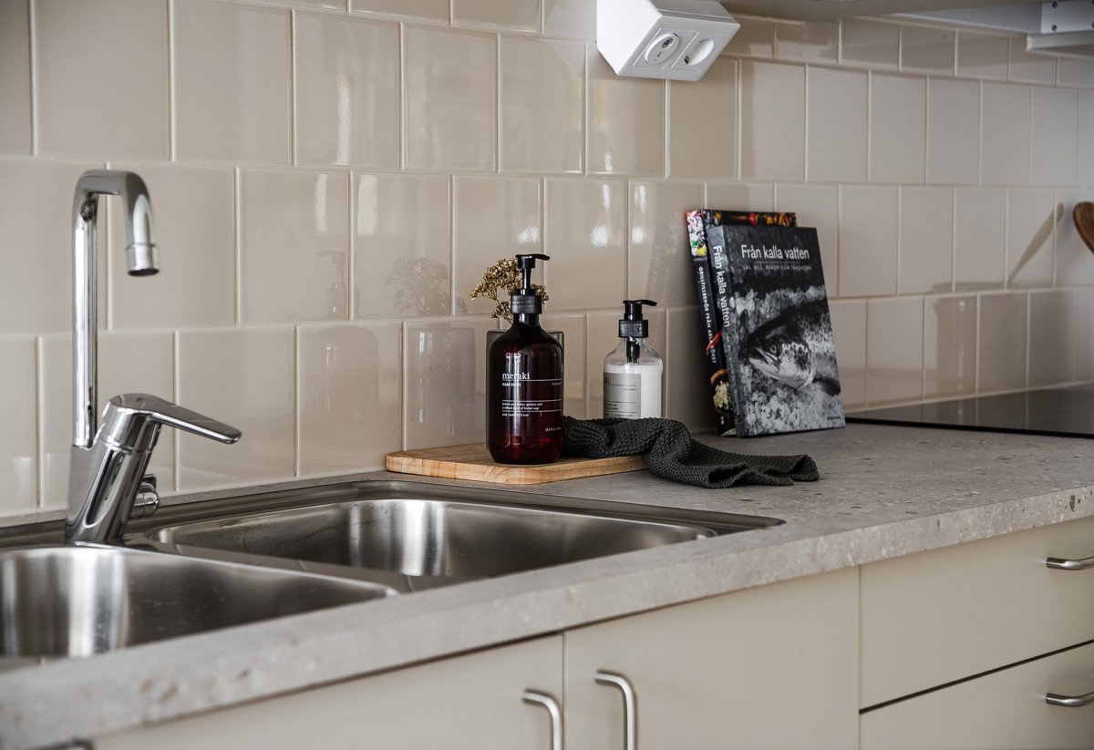 Visningslägenhet i Atlantis med fokus på luckor, bänkskiva och stänkskydd i kök